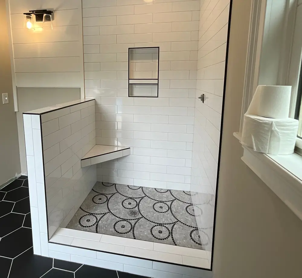 Walk-in shower with custom circle-mosaic feature floor and bench, Atlanta