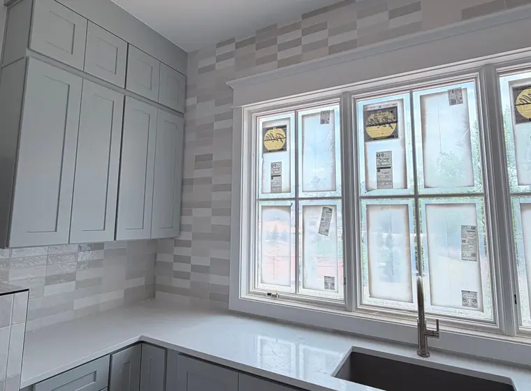Kitchen backsplash in vertical stacked tile over quartz counters
