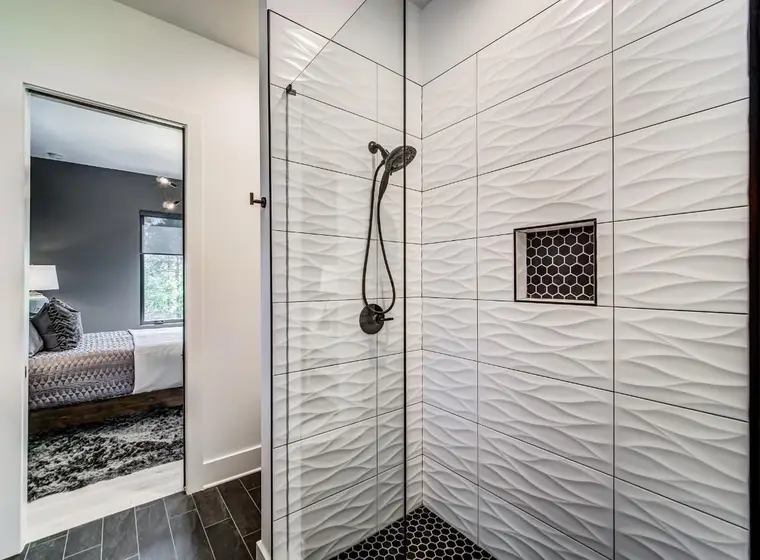 3D wave tile shower beside master bedroom