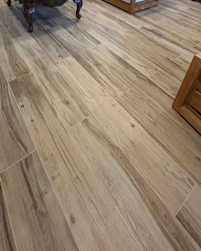 Wood-look porcelain plank flooring installed through a living room