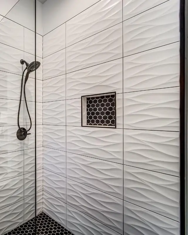 Sculpted 3D wave tile shower wall with black hex niche