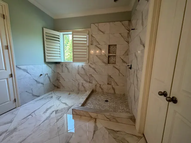 Calacatta-look walk-in shower with shuttered window, Atlanta GA