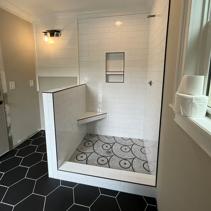 White subway shower with black hex floor and bench, Atlanta GA