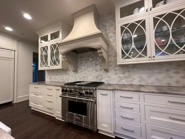 Fish-scale marble mosaic backsplash behind a pro range, Atlanta GA