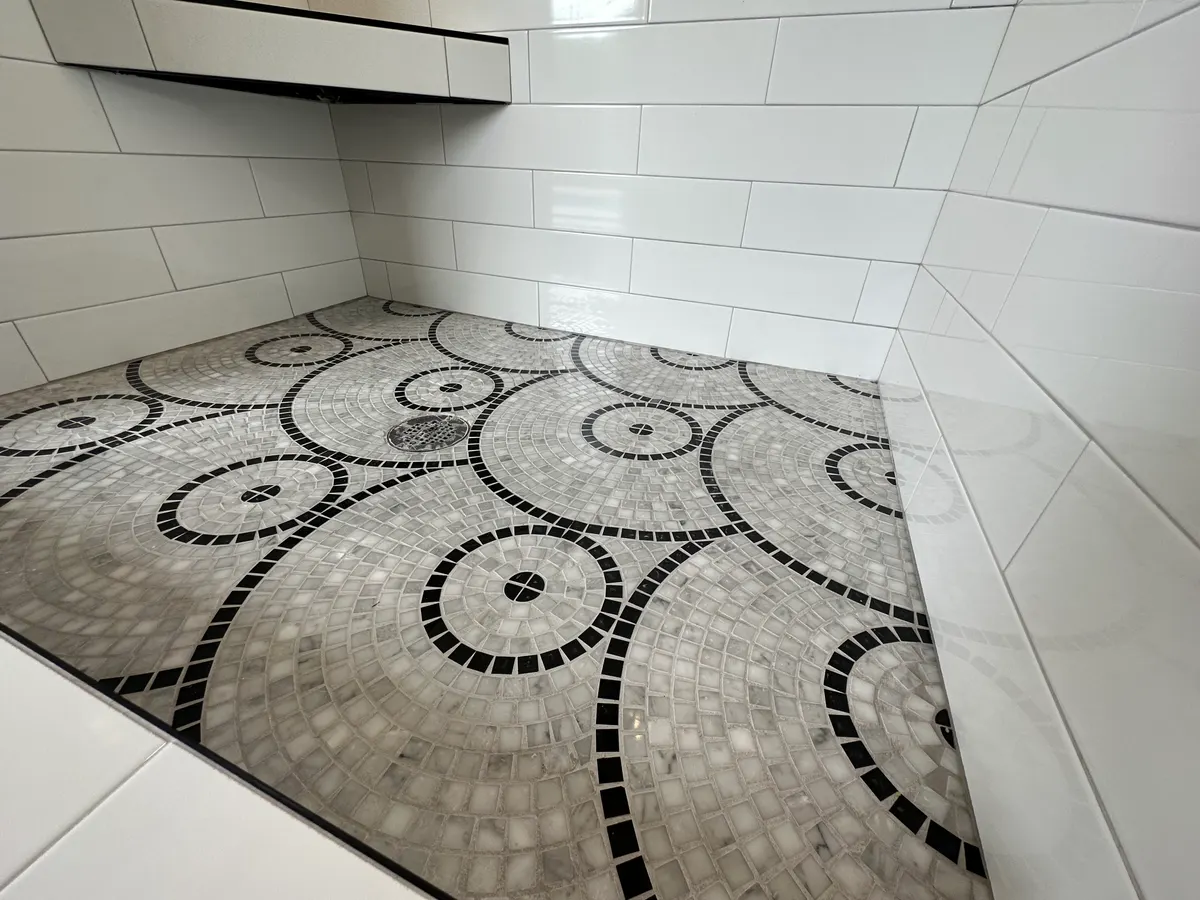 Custom circle-fan mosaic floor hand set in black and white marble